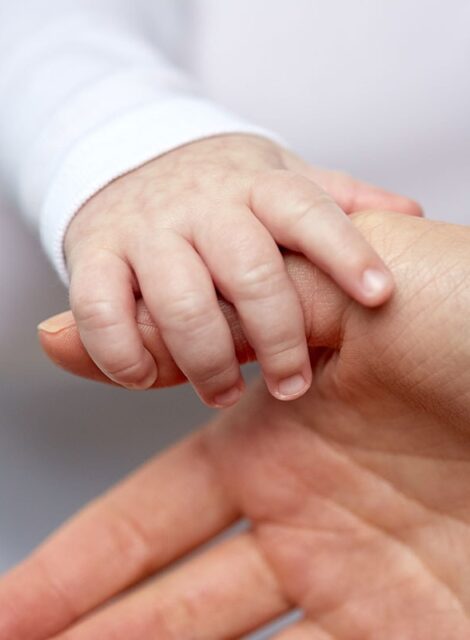 close-up-of-mother-and-newborn-baby-hands